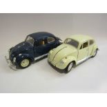 Two 1:18 scale diecast VW Beetles