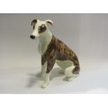 A Winstanley seated whippet,