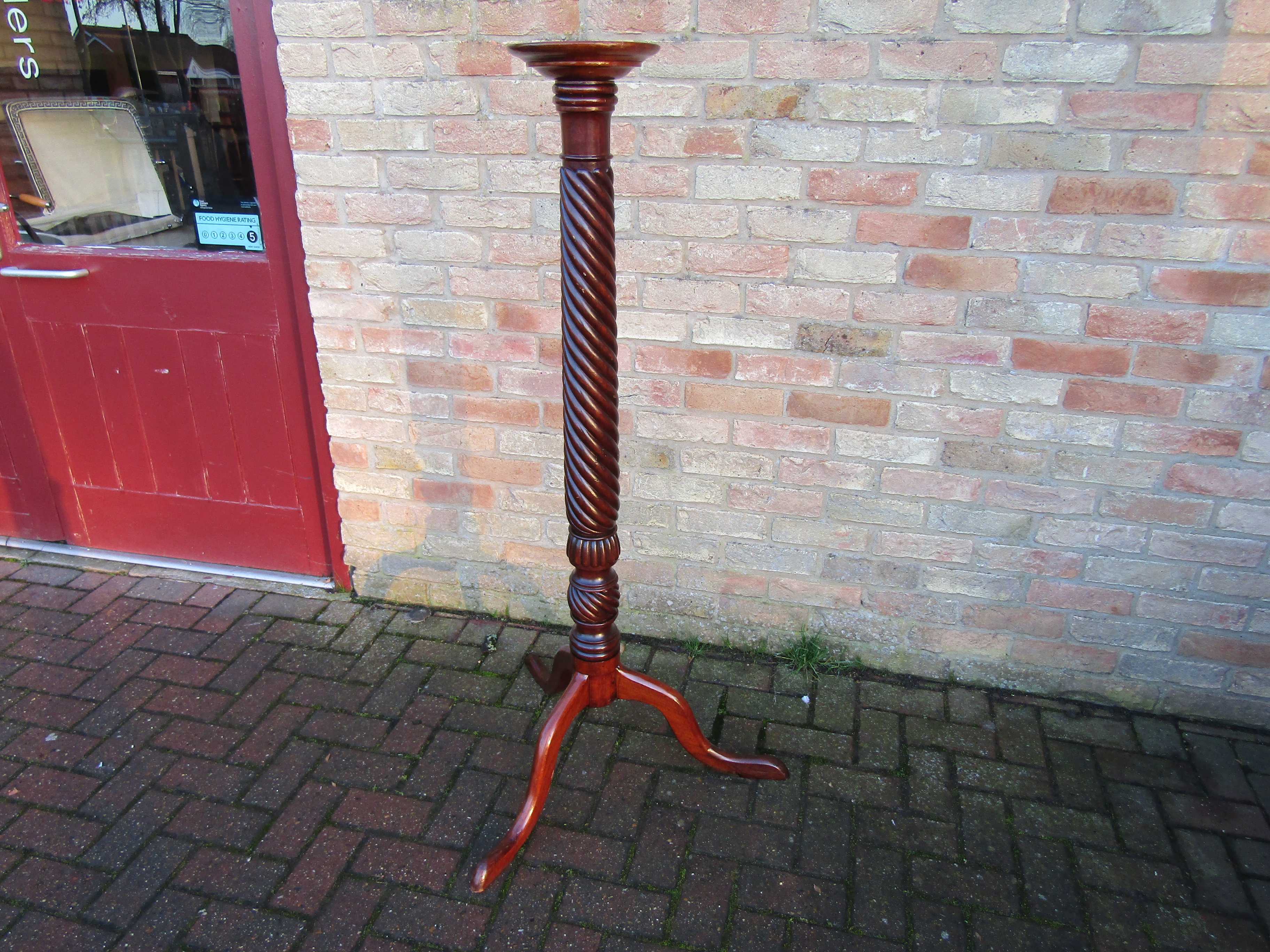 A Victorian mahogany torchere with tripod base,