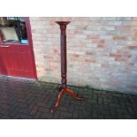 A Victorian mahogany torchere with tripod base,