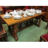 A medium oak 17th Century style refectory dining table on turned legs joined by an H stretcher.