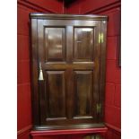 A mahogany panelled corner cupboard with H bracket hinges,