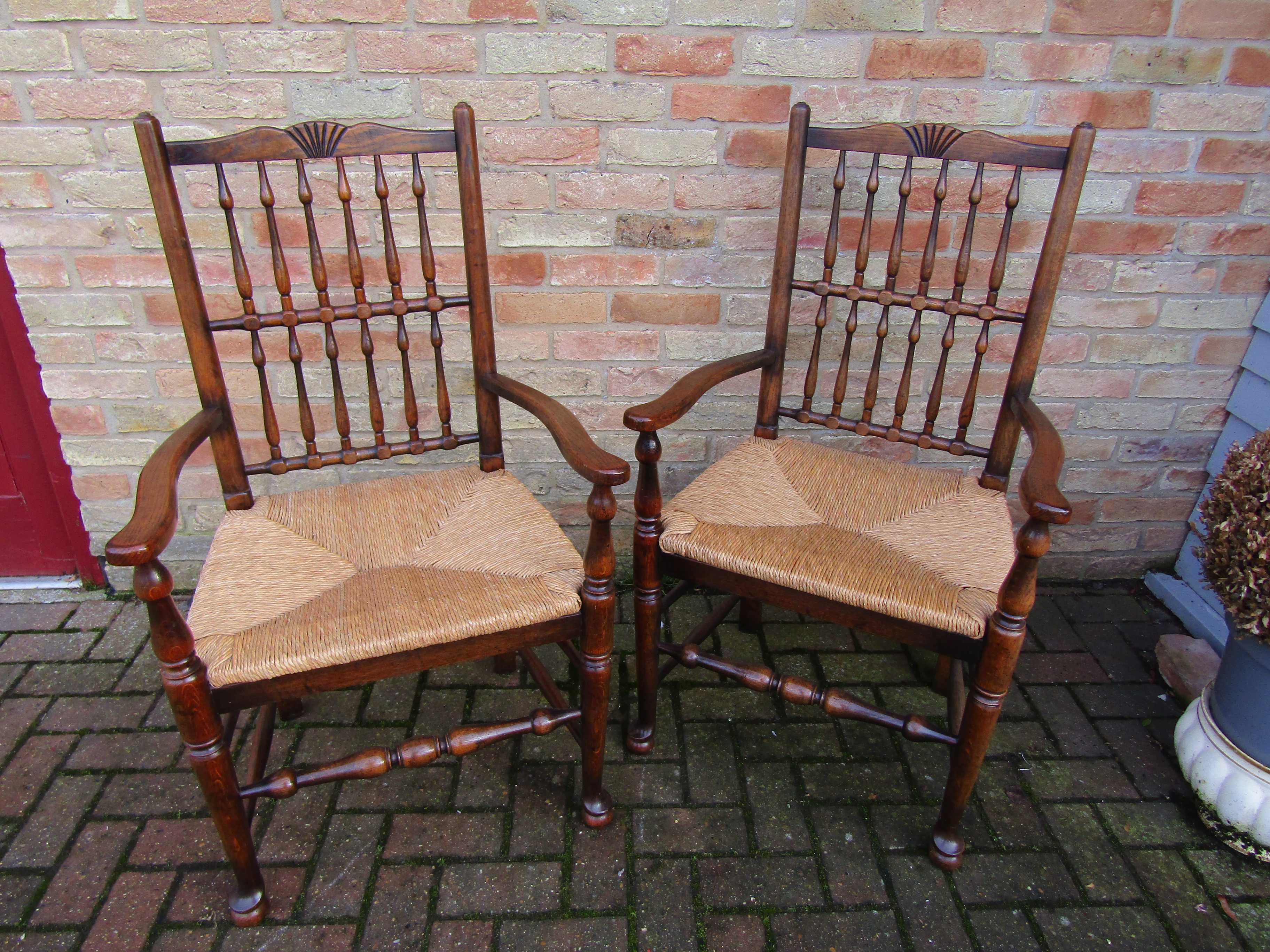 A set of eight (6+2) oak spindle back and rush seated dining chairs