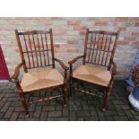 A set of eight (6+2) oak spindle back and rush seated dining chairs