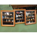 Three display cases of miniature novelty clocks