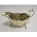 A silver sauce boat (dented)
