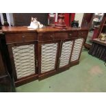 A Regency mahogany breakfront sideboard with lattice brass panelled doors,