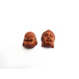 Two carved wood face netsuke