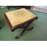 A Victorian mahogany scrolled throne stool with Greek style upholstery,