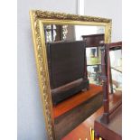 A large rectangular ornate gilt frame bevelled edge mirror,