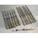 Mostly silver handled knives and forks