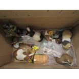 A box containing mixed figures including guinea pig figures