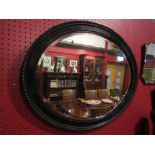 A Victorian ebonised oval mirror,