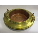 A brass and copper twin handled bowl