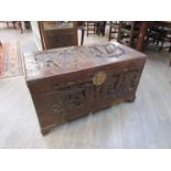 An early to mid 20th Century heavily carved Oriental camphor wood chest,