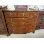 A Georgian inlaid mahogany bow front three over three chest of drawers