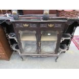 An Edwardian carved credenza base cabinet with glazed doors