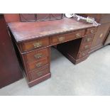 A late Victorian walnut twin pedestal desk with nine drawers,