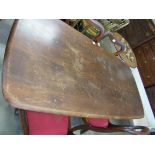 A dark Ercol dining table,