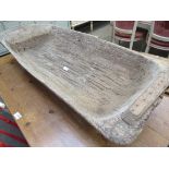 A large rustic dug out timber trough