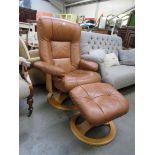 A Stressless style tan leather reclining armchair and footstool