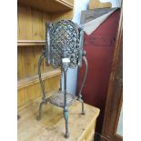 A cast pierced metal planter on stand
