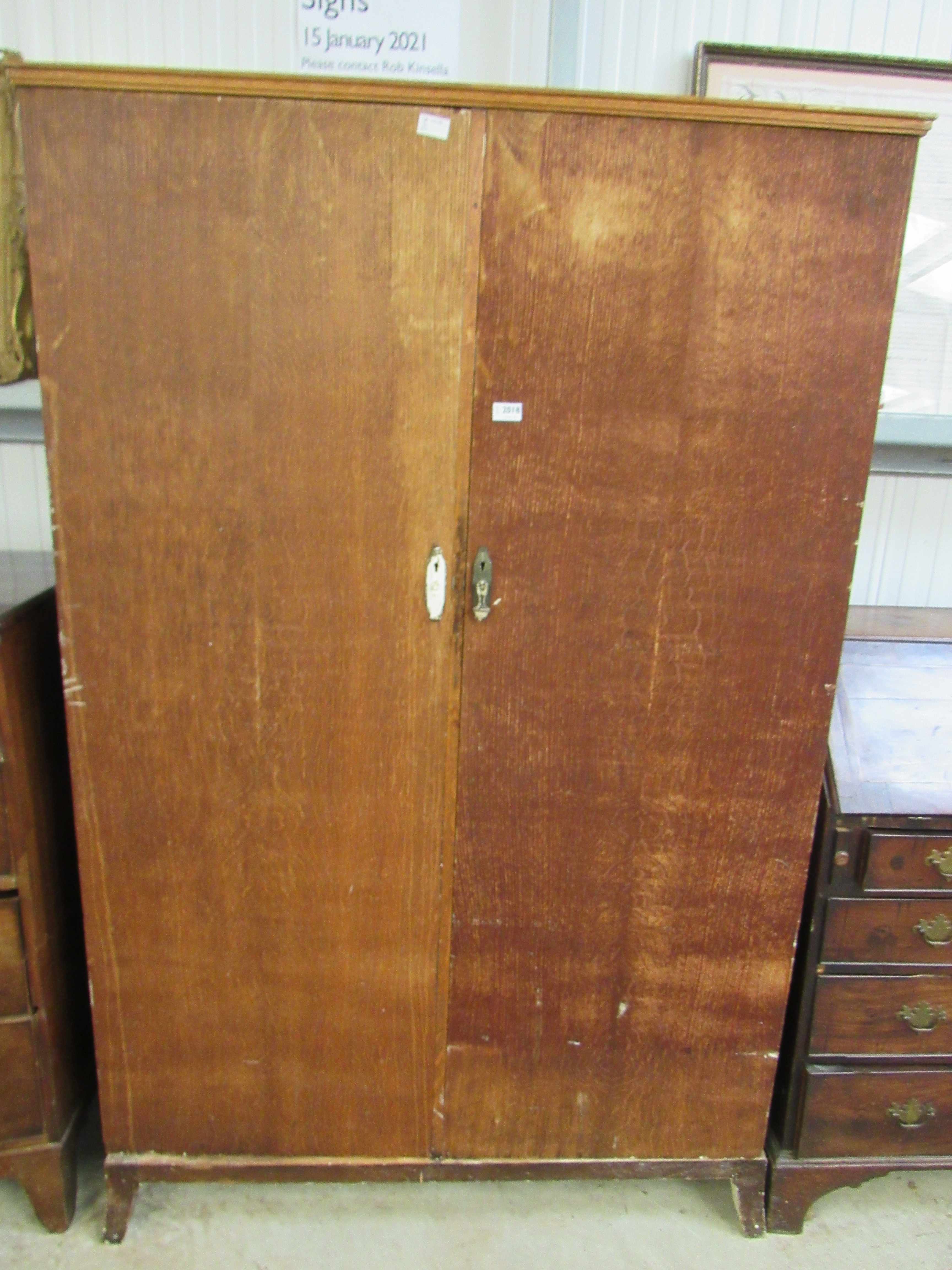 A Waring and Gillow stripped oak gentleman's wardrobe with fitted interior