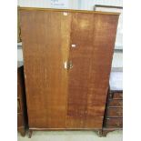 A Waring and Gillow stripped oak gentleman's wardrobe with fitted interior