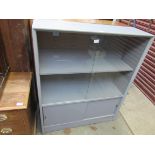 A 1970s retro grey painted glazed bookcase with plinth base