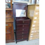 A Stag Minstrel dressing chest of slim proportions with lift top to reveal mirror