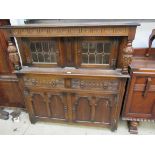 A 1950's carved oak court cupboard