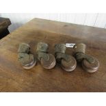 A set of four brass and brown porcelain table castors