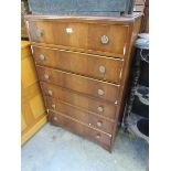 A 1950's oak veneered chest of six drawers