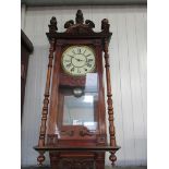 An early 20th Century mahogany and walnut Vienna wall clock