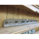 A timber seven hook coat rail
