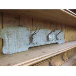 Three wire coat hooks on an Art Nouveau shaped timer panel