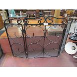 A wrought iron three fold fire guard