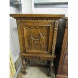 A small Continental carved oak cupboard on stand