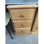 A pine three drawer bedside chest