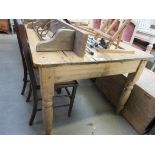 A Victorian waxed pine scrub top kitchen table on turned legs with a side drawer,