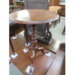 A Victorian mahogany circular top wine table on a tripod base