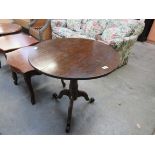 A George III oak tripod wine table with modified wrought iron feet