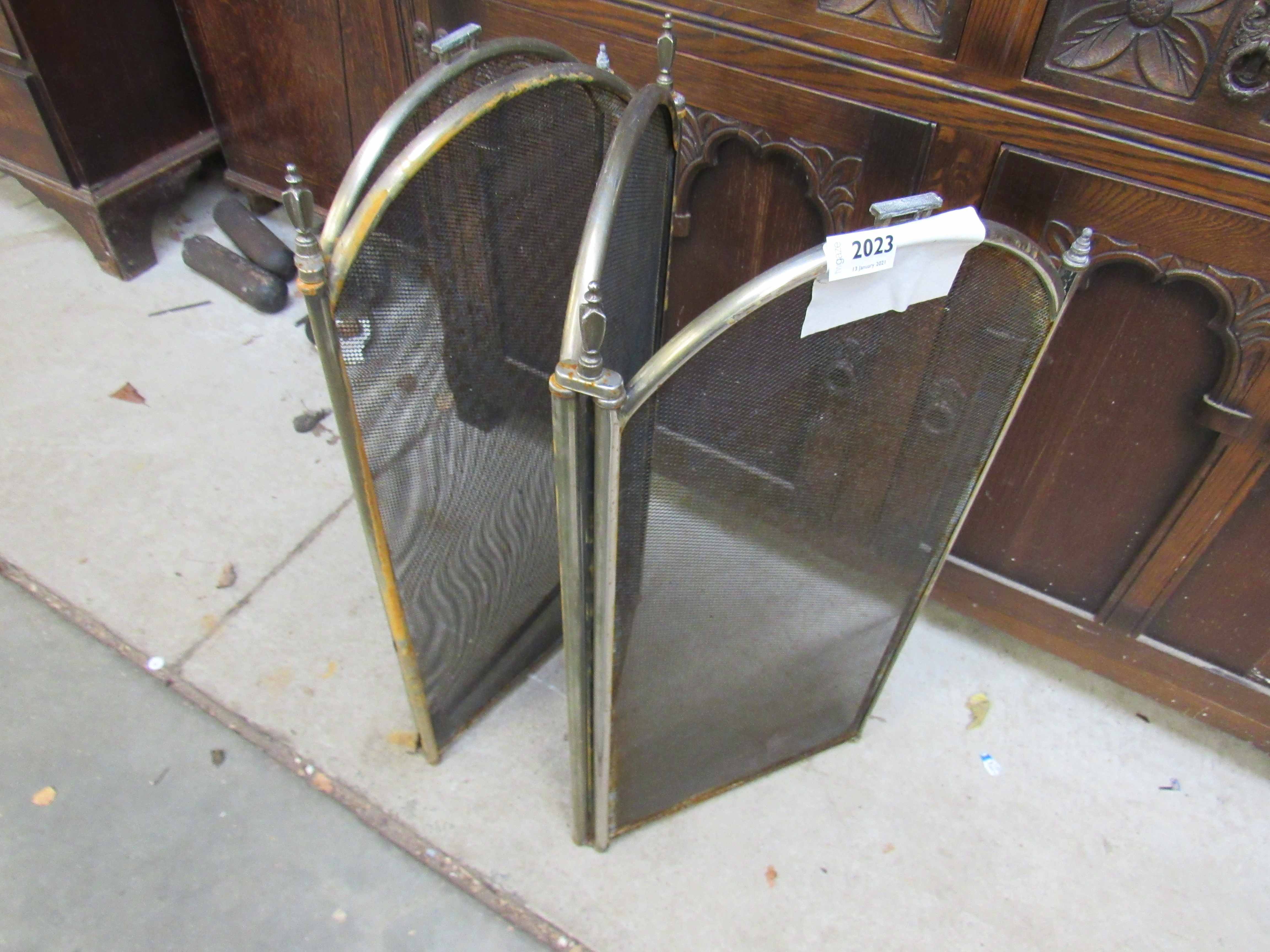 A brass folding four section fire guard