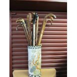 An Oriental stick stand containing 17 sticks,