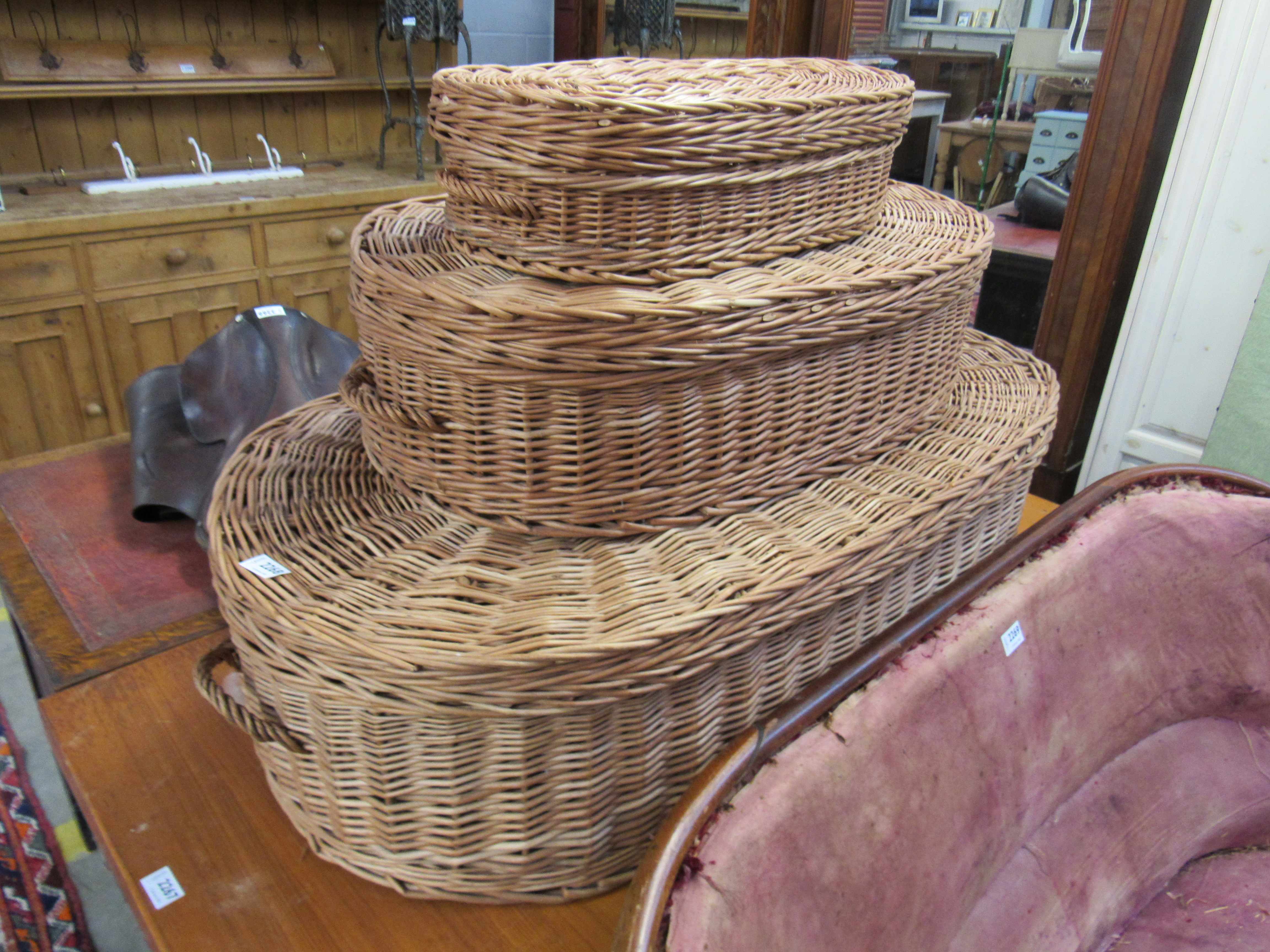 A set of three graduating wicker lidded baskets
