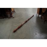 A timber curtain pole and rings,