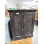 A vintage stained pine two door workshop cabinet stained