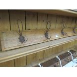 Four wire coat hooks on timber rail
