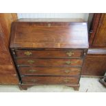 A George III mahogany bureau, fall front over four graduating long drawers,