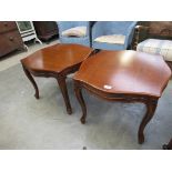 A pair of French style serpentine top lamp tables on carved cabriole legs,